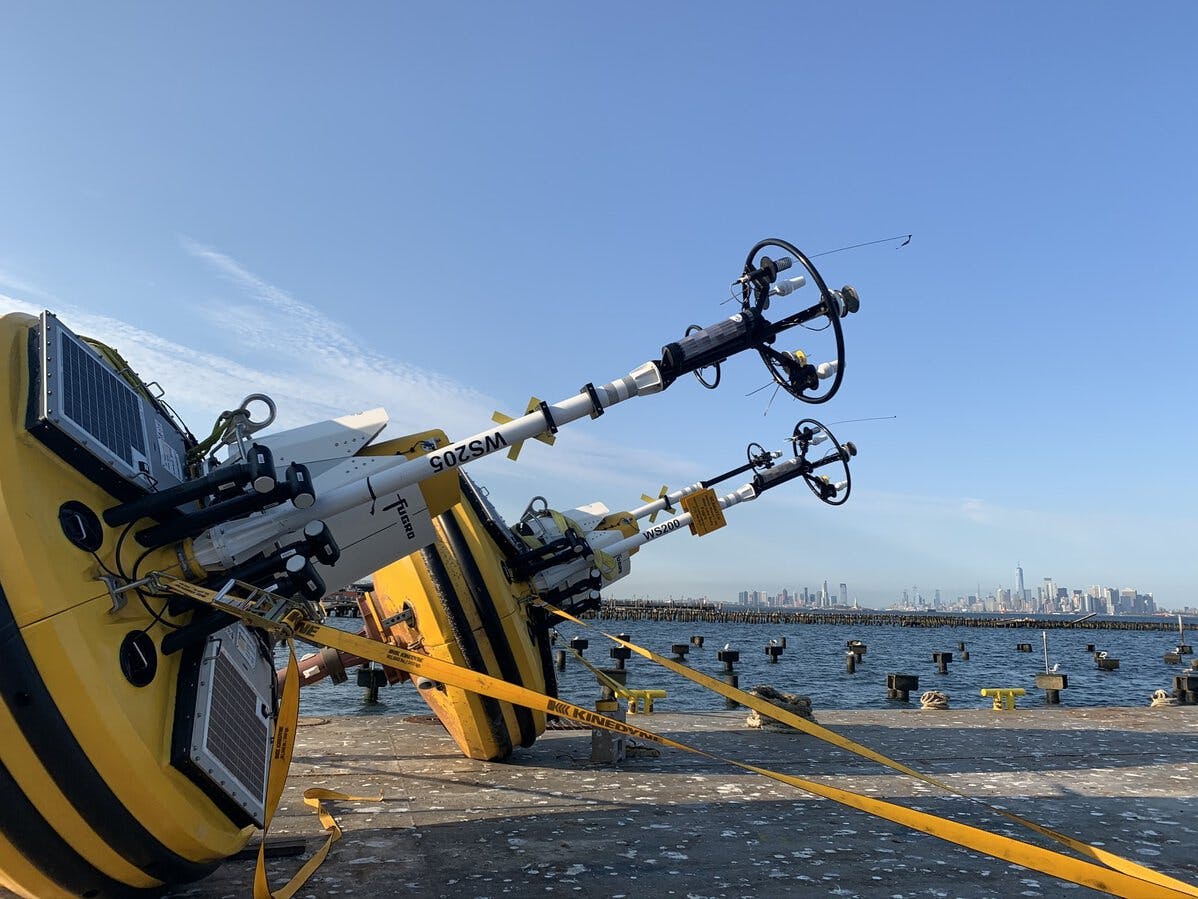 SEAWATCH� wind LiDAR buoys staged on barge for transfer to vessel - New York City in background.