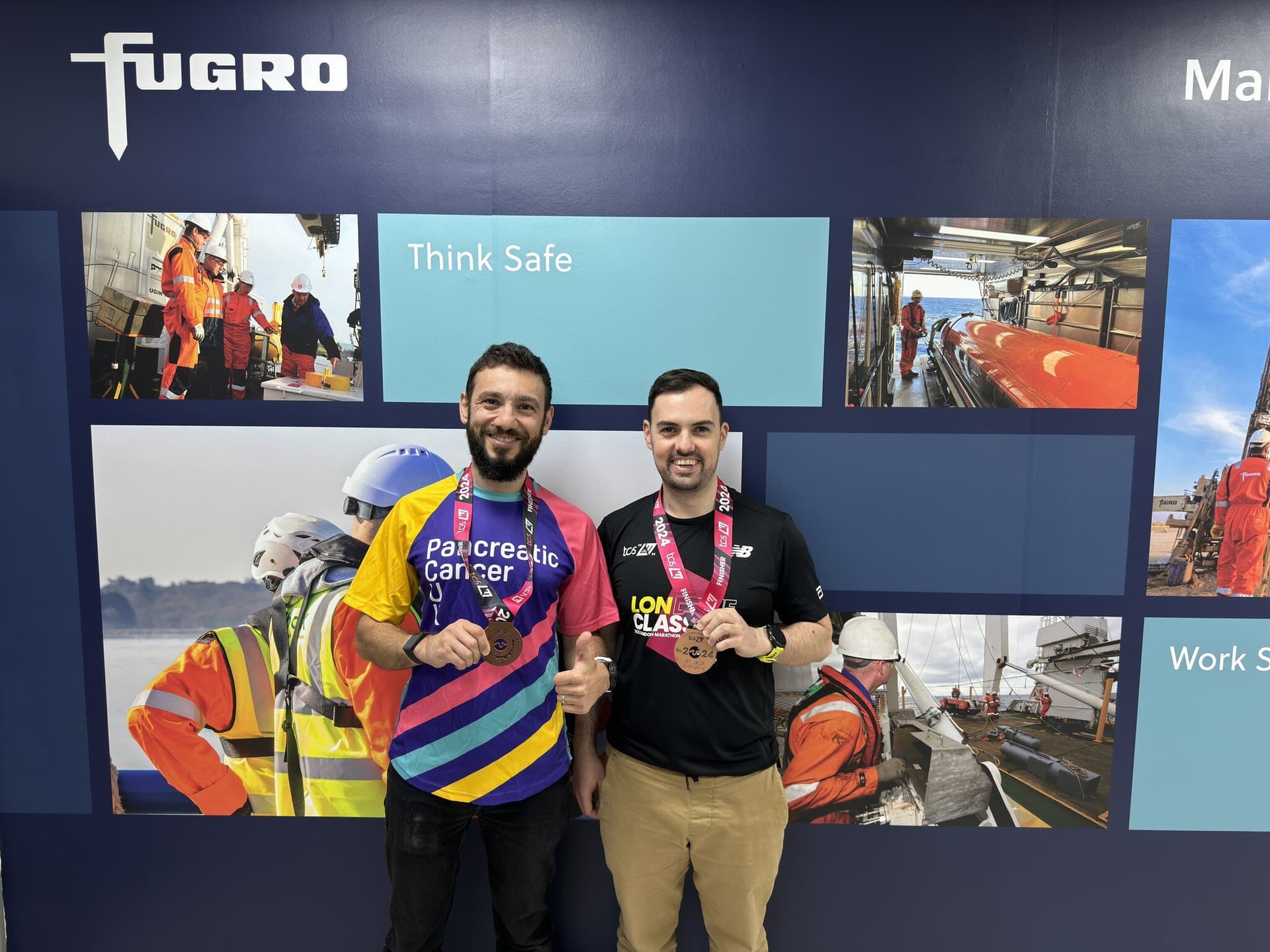 Ross MacFarlane and Hidayat Alizada, showing medals from their 2024 London Marathon